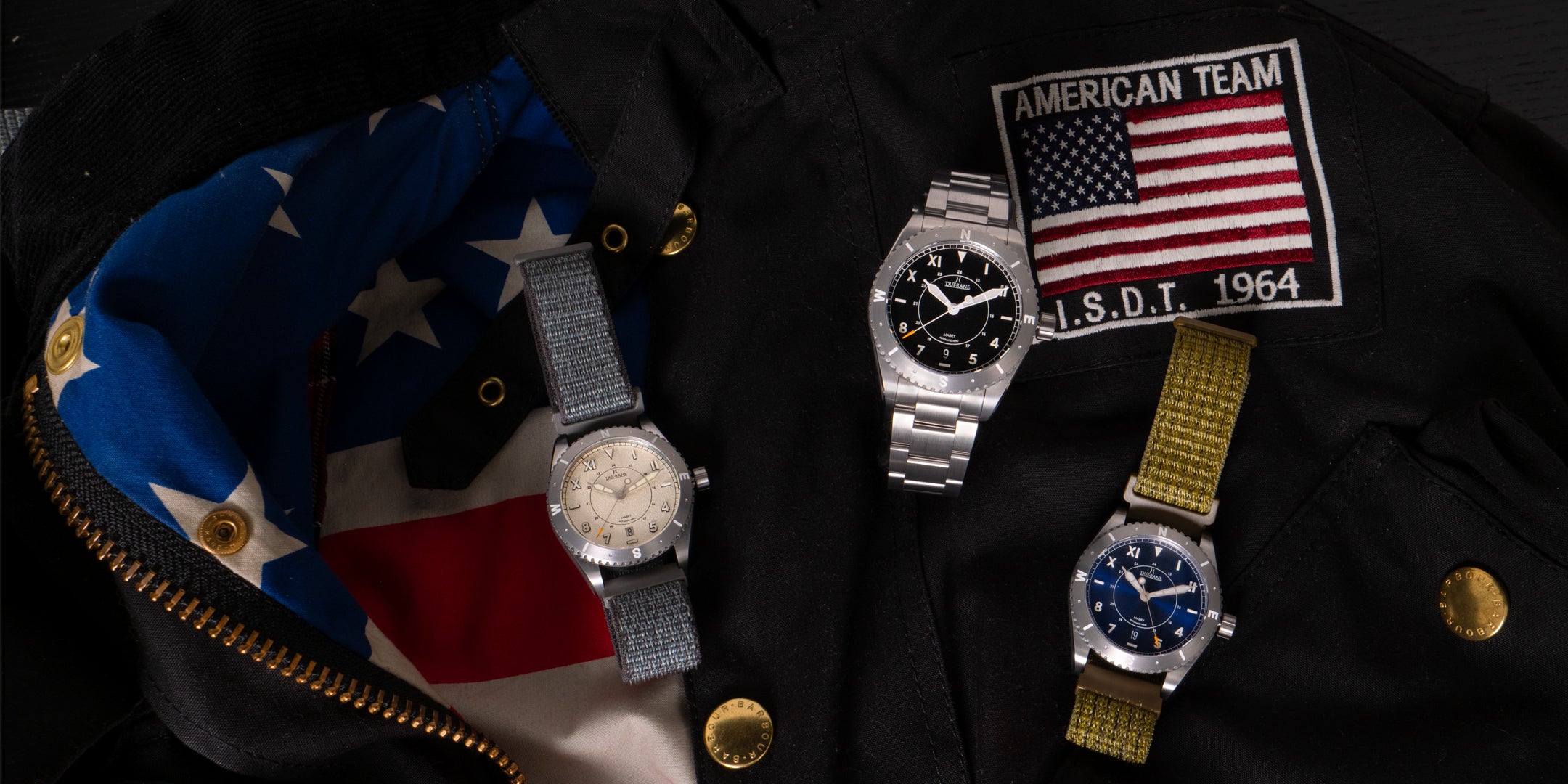 Three watches on a dark surface with American flags and patches.