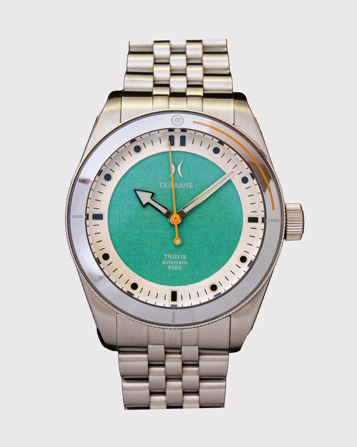 Silver watch with a green face on a white background
