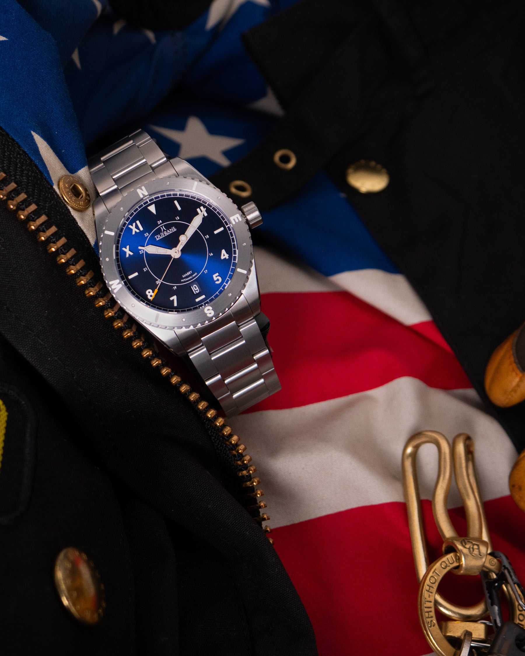 Silver watch with blue face on a flag background