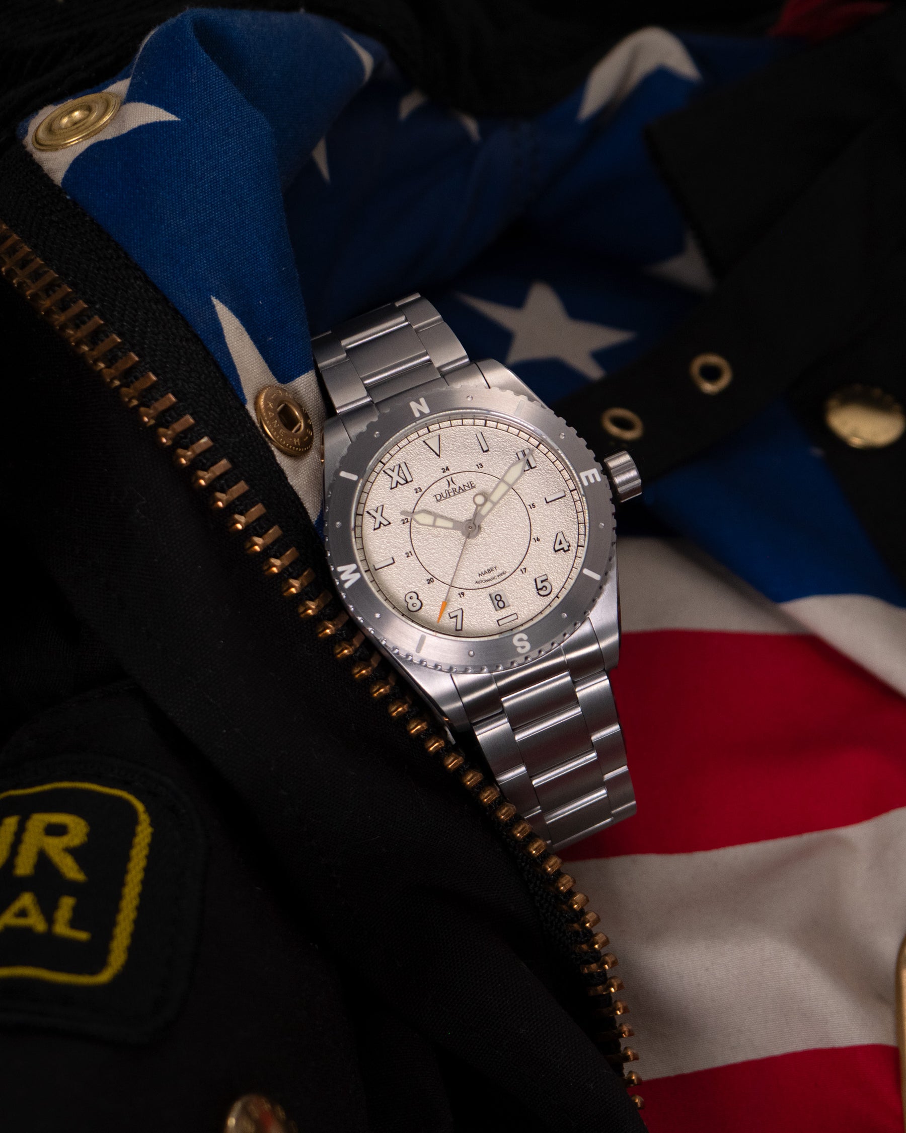 Silver watch on a flag background
